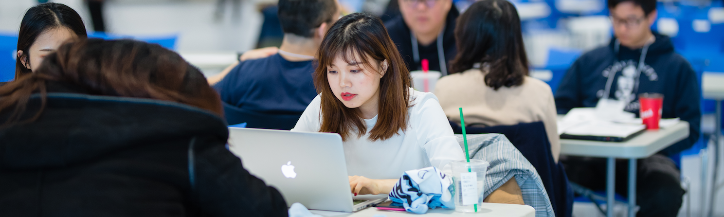 Students sitting in front of computer analyzing data