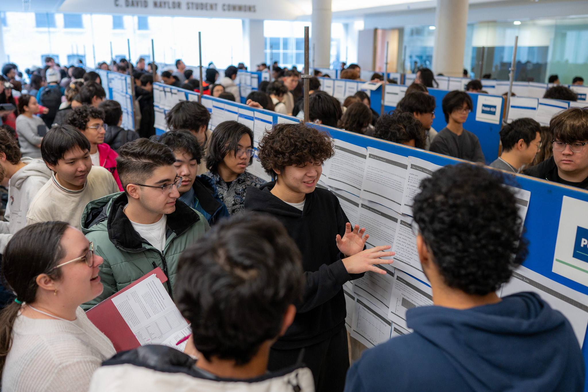 Professor Nathalie Moon, teaching stream faculty member and STA130 course coordinator, grading student presentations at the 2025 STA130 Poster Fair in the Medical Sciences Building.