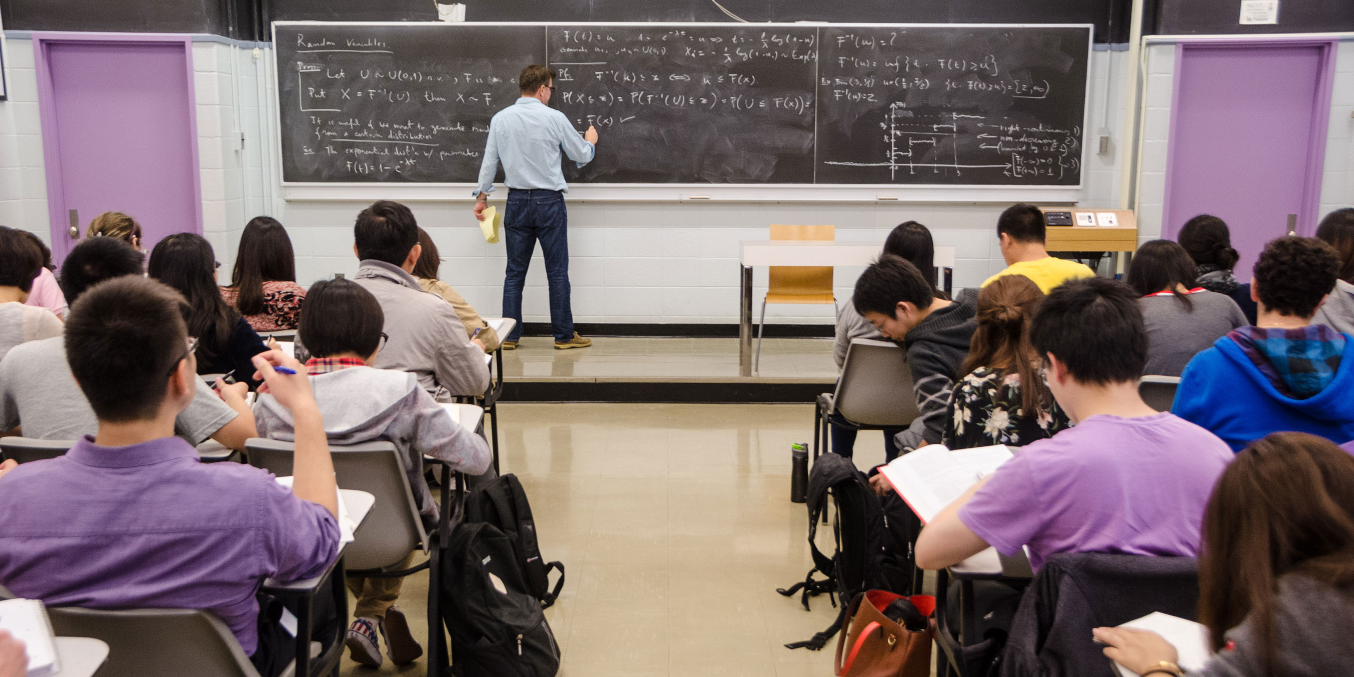 Group of students in a classroom on their laptops