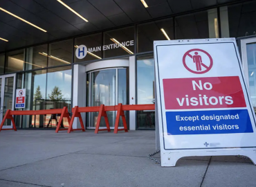 Main entrance to hospital with Covid signage