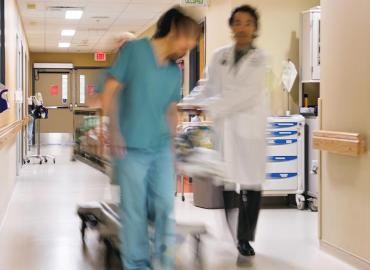 doctors walking along hospital hallway