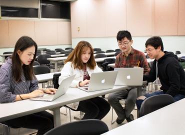 Group of students in a classroom on their laptops